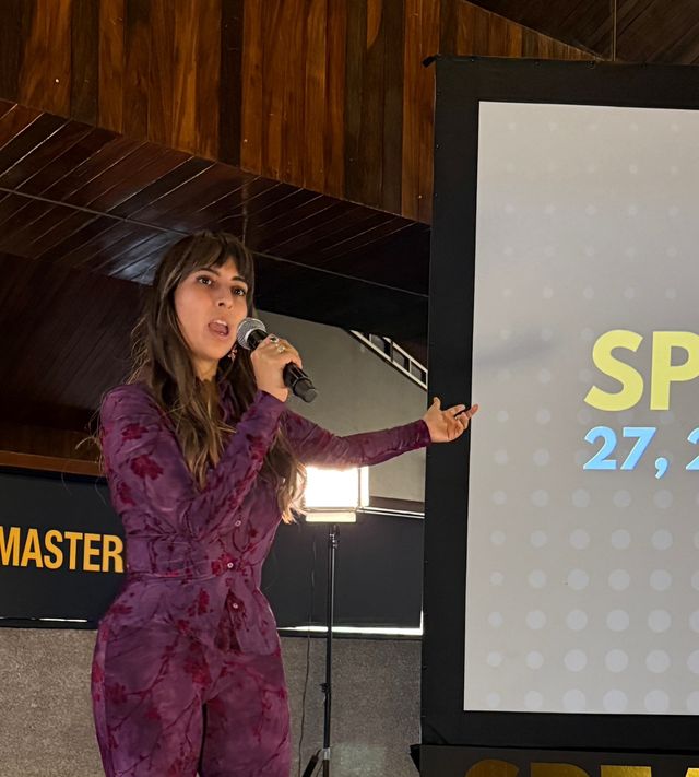 Alejandra Endara speaking on stage with a microphone