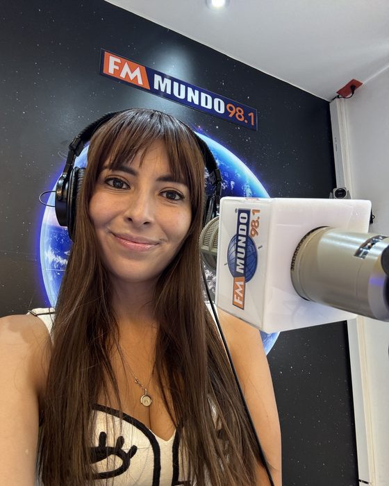Alejandra Endara wearing headphones in the FM Mundo radio studio